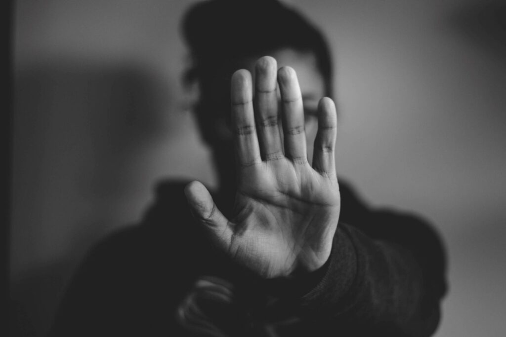 Person raising hand to say "Stop"
