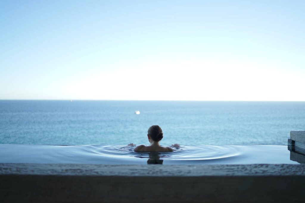 Woman relaxing in infinity pool