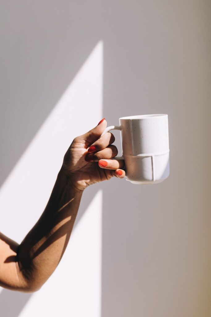 Person holding a coffee cup