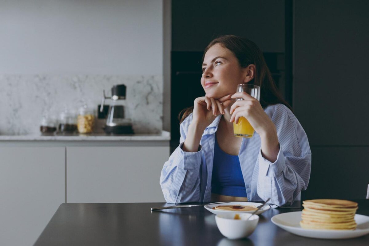 Person eating breakfast thoughtfully